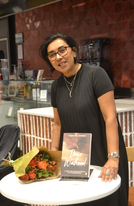Farhana Yunnus, founder of House of Ayaat, holding her book Dear Waheed